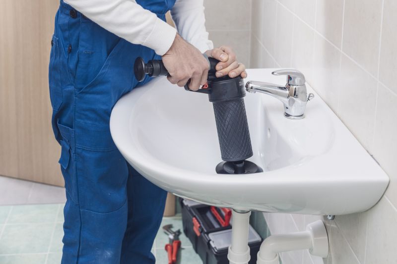 Plumber Clearing a Clogged Drain